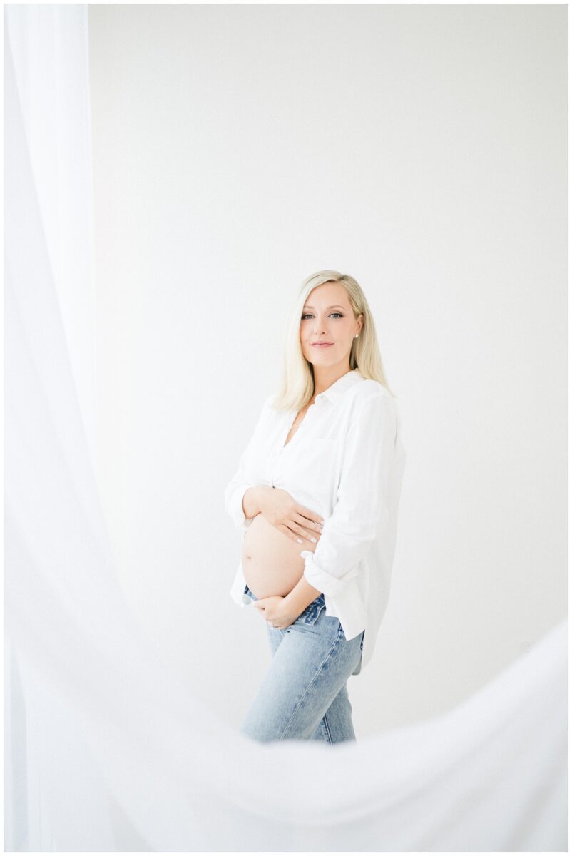 modern maternity session with white shirt and denim jeans