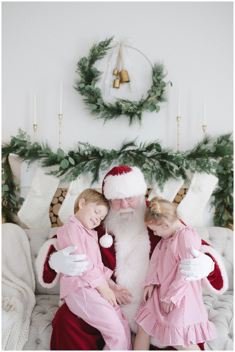 two children with santa hugs